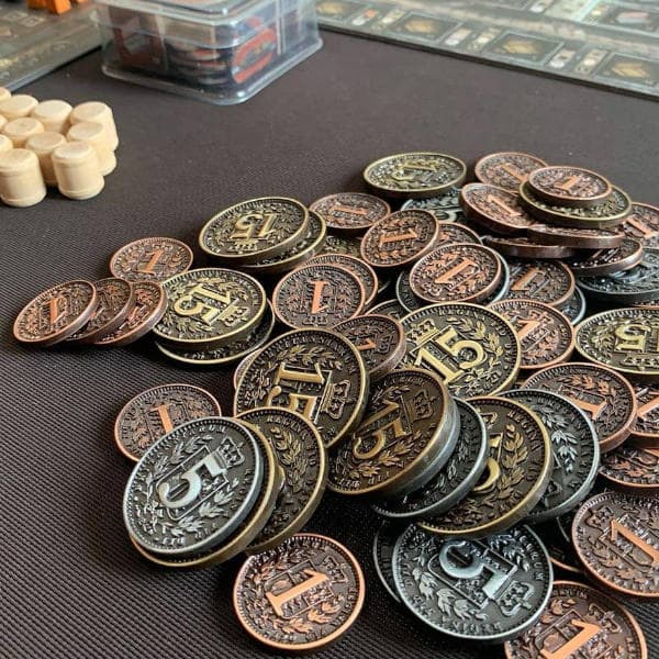 Brass Metal Coins spread out on table.