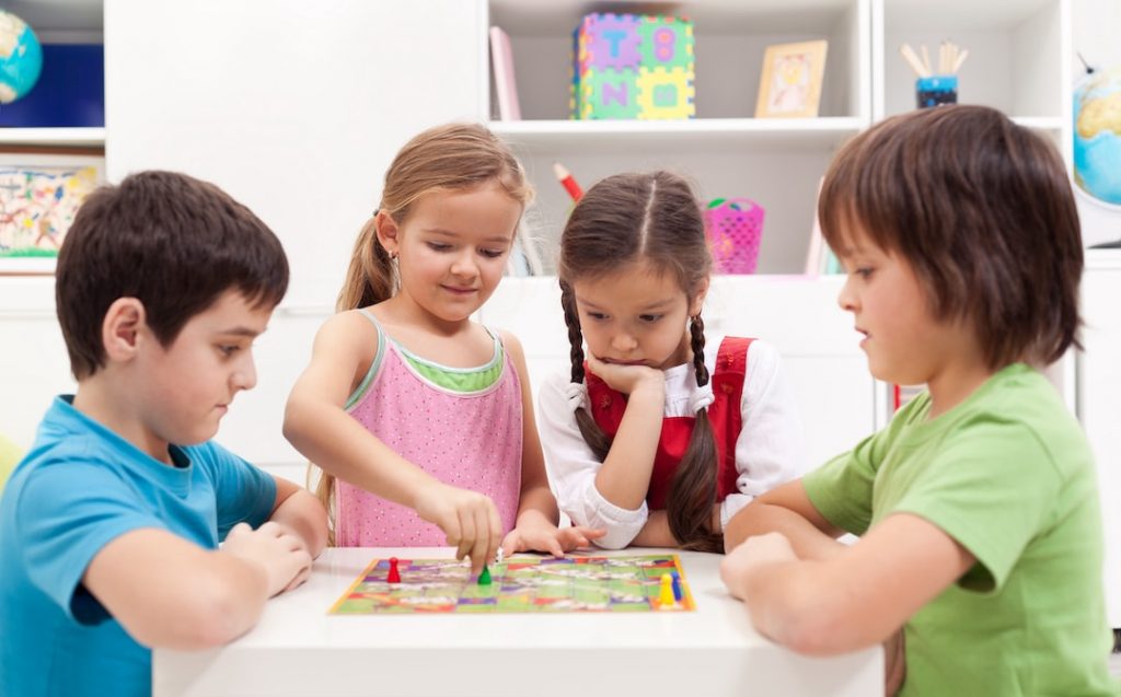 Kids Playing a Board Game | Featured image for Top 10 Kids Board Games blog.