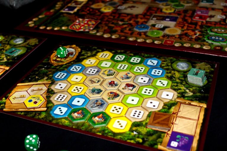 One of the bet tile placement games, Castles of Burgundy, being played | Featured image for the Best Tile Placement Board Games blog from More Than Meeples.