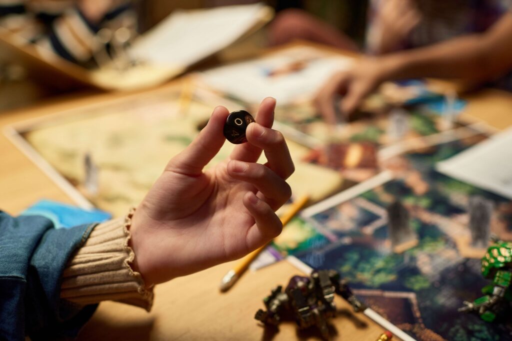 Person holding dice | Featured image for the best board games of 2021 blog.