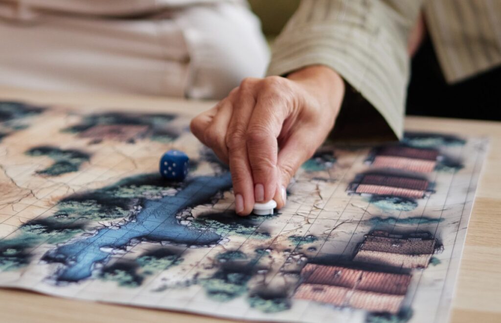 hand moving board game pieces | Featured image of the Spiel des Jahres 2015 blog page
