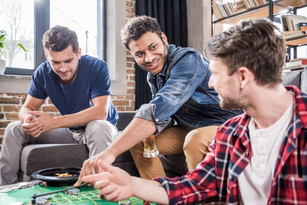 Young men playing a board game | Featured image of the 7 Hidden Gems: Underrated Board Games You Should Try blog