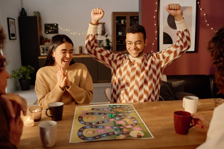 Friends play a board game.