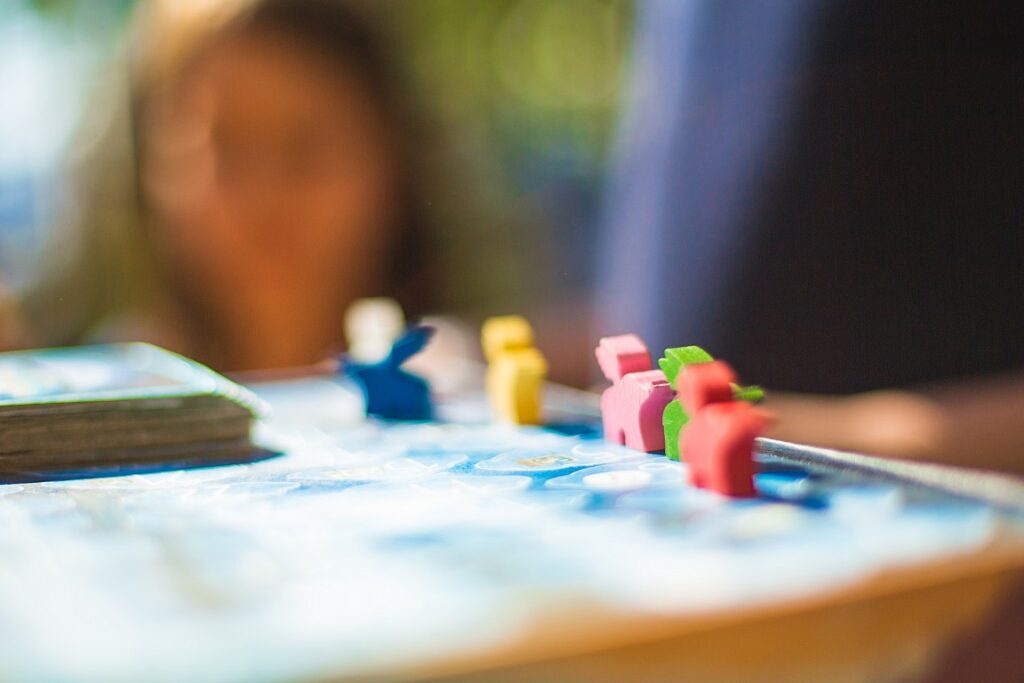 Brightly coloured game pieces. | Featured image of the Relaxing Solo Board Games for a Calm Night