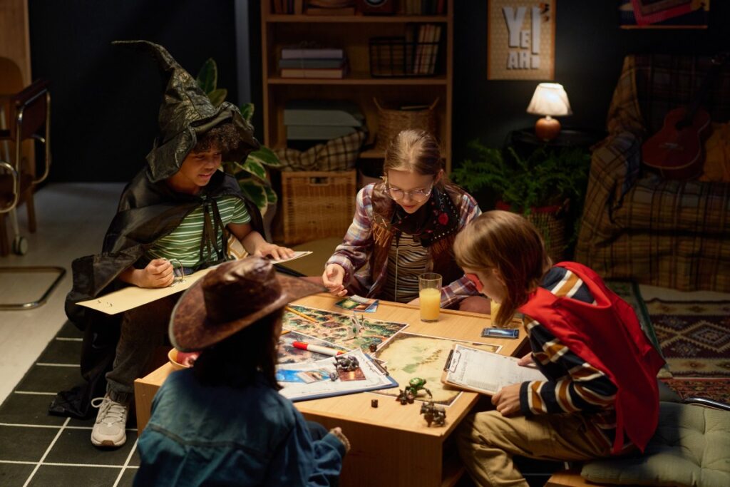 children in costume while playing a board game