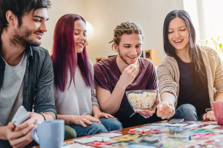 Group of friends gathered around a table to play board games | Featured Image for the Sci-Fi Showdowns: Best Futuristic Board Games blog.